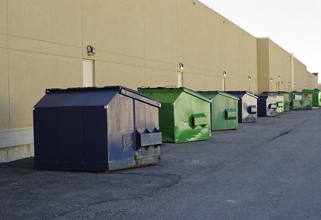 an assortment of sturdy and reliable waste containers near a construction area in Felton